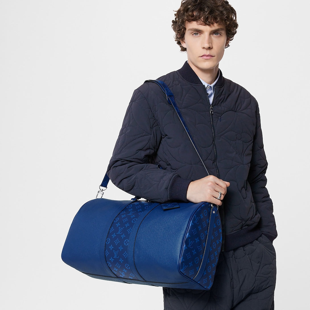 Sac Keepall Bandoulière 50  Louis Vuitton en cuir bleu avec bande centrale Monogram